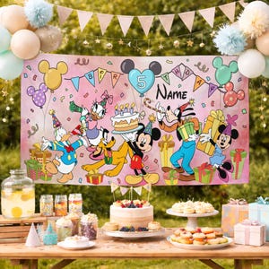 May include: A pink birthday banner featuring Disney characters Mickey Mouse, Minnie Mouse, Donald Duck, Goofy, and Pluto. The banner has the word "BIRTHDAY" and space for a name. The scene includes balloons, gifts, and a cake, with a party table in the foreground.