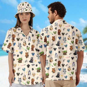 May include: Cream-coloured button-down shirt and bucket hat with a Star Wars pattern. The design includes characters, lightsabers, and balloons. The shirt has short sleeves and a classic collar.