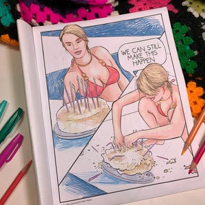 May include: A coloring book page featuring a woman in a red bikini with a birthday cake. The text in the speech bubble says, "WE CAN STILL MAKE THIS HAPPEN." The page is open, with colored pencils and pens visible.