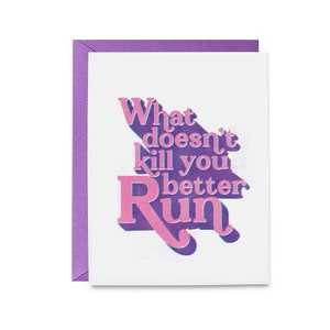 May include: A white card with a purple border and the text "What doesn't kill you better run" in pink and blue letters with a shadow effect.