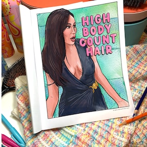 May include: A coloring book page with the text "HIGH BODY COUNT HAIR" in pink bubble letters. The illustration depicts a woman in a dark blue dress. Hair styling tools and colorful pens surround the book.