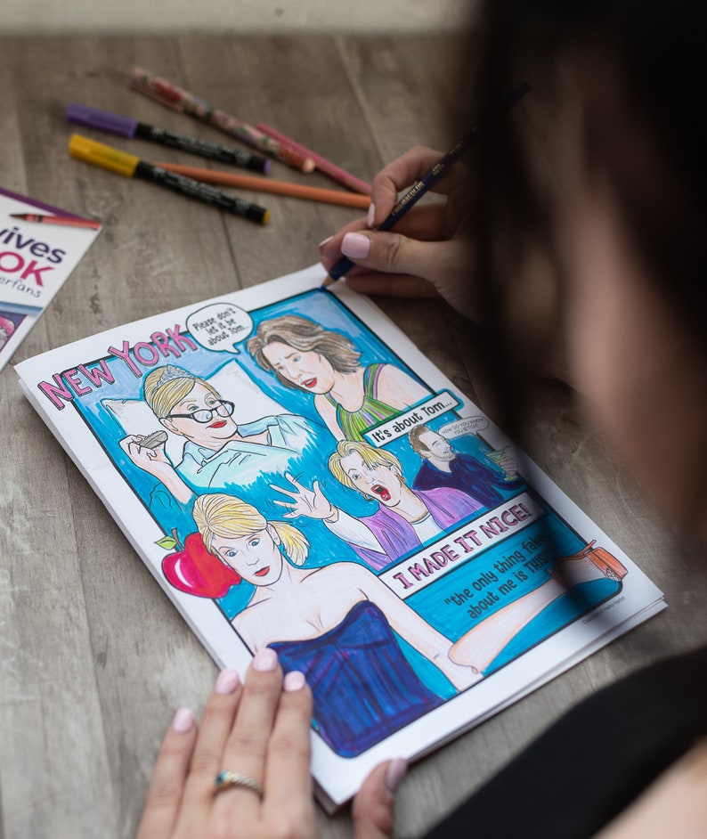 May include: A colourful comic book illustration with the words "NEW YORK" and speech bubbles. The artwork features drawings of people and the phrases "Please don't let it be about Tom" and "I MADE IT NICE!"