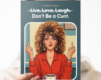 May include: A greeting card with the text "Live, Love, Laugh... Don't Be a Cunt." The card features an illustration of a woman with big hair, wearing a red shirt, and giving the middle finger. The card is held in front of a person.