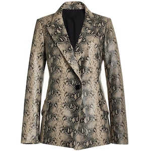 May include: A long-sleeve blazer featuring a tan and black snakeskin pattern. The garment has a notched lapel, a single black button closure at the centre, and two flap pockets on the front. The interior lining is solid black.