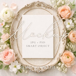 May include: A mockup image featuring a blank white card centered on an ornate, cream-colored oval frame. The frame is surrounded by peach and white roses, baby's breath, and greenery. The text "Mockup" and "JPG + PSD SMART OBJECT" are overlaid on the card.