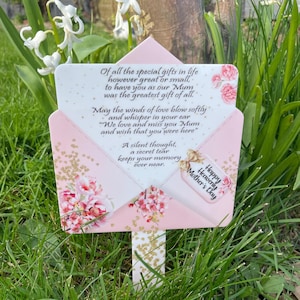 May include: A pink and white card with a floral design and gold glitter. The card has a message about the special gift of a mother and a happy heavenly mother's day message.