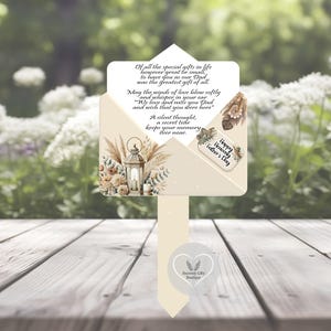 May include: A beige memorial garden stake with a decorative envelope design. The envelope features floral and lantern illustrations, with text that reads "Happy Heavenly Father's Day." The stake includes a heartfelt poem.