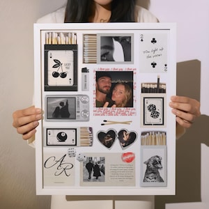 May include: A white framed collage featuring various images and objects. Includes playing cards, photos, matchboxes, dice, and a lighter. Some cards have text like "Lucky You" and "You light up the room".
