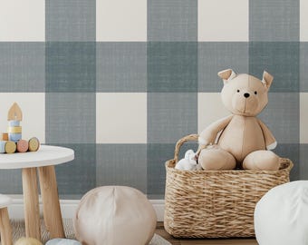 May include: Wallpaper featuring a large-scale buffalo check pattern in muted blue-gray and off-white with a subtle fabric-like texture. The design consists of alternating solid-colored squares creating a grid across the entire surface.