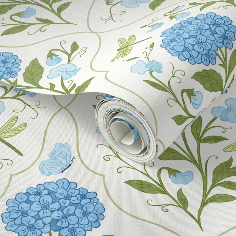 May include: White wallpaper with a repeating pattern of blue hydrangeas, butterflies, and dragonflies, accented by green leaves and stems. The design includes a scrolling, light green trellis-like outline.