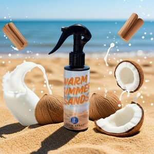 May include: A room spray bottle with a black nozzle and the words "Warm Summer Sands" in orange. The image includes coconuts, cinnamon sticks, and a splash of liquid, all on a sandy beach with the ocean in the background.