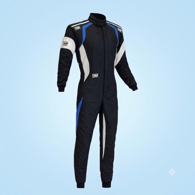 May include: A black racing suit featuring a high collar, long sleeves, and a front zipper closure. The garment is accented with white and blue panels along the shoulders, chest, and legs, and includes the OMP logo printed on the chest and sleeves.