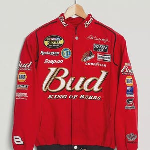 May include: Red Budweiser racing jacket with multiple sponsor patches, including NASCAR, Snap-on, and Goodyear. The jacket features the Budweiser logo and the text "KING OF BEERS."
