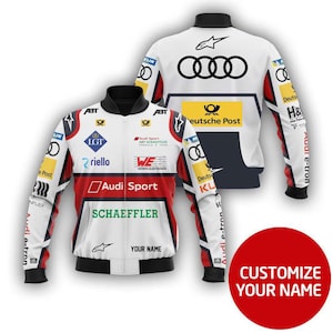 May include: A white and red racing jacket with black accents, featuring logos for Audi Sport, Schaeffler, and Deutsche Post. The jacket has a zip-up front and a black collar. The text "YOUR NAME" is visible on the front. The back of the jacket has the Audi logo.