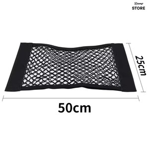 K&ouml;nnte beinhalten: Ein rechteckiges, schwarzes elastisches Aufbewahrungsnetz mit Gittermuster und festen schwarzen Stoffr&auml;ndern an den linken und rechten Seiten. Das Netz ist mit den Ma&szlig;en 50 cm Breite und 25 cm H&ouml;he sowie dem Text Xramp STORE gekennzeichnet.