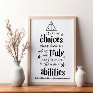 May include: A framed wall art print featuring black text on a white background that reads: It is our choices that show us what truly we are far more than our abilities. The design includes a triangle symbol at the top and a wand graphic below.