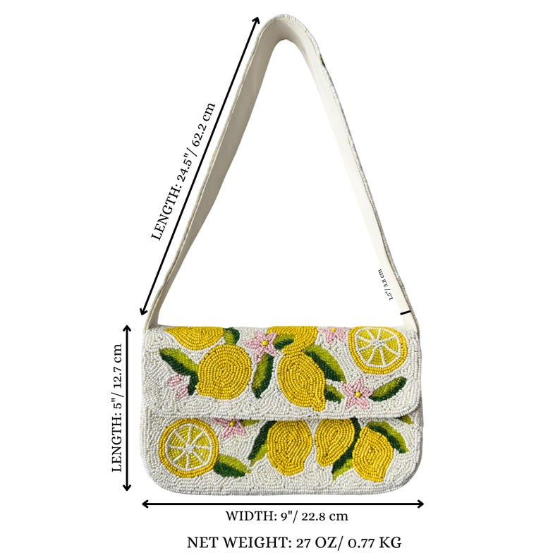 May include: A white beaded shoulder bag with a lemon design. The bag is 9 inches wide, 5 inches tall, and 24.5 inches long, with a net weight of 27 ounces. The bag features yellow lemons, green leaves, and pink flowers.