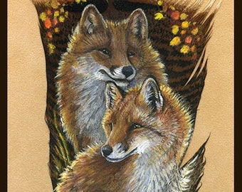 May include: A large bird feather featuring a detailed painting of two foxes with reddish-brown fur and white chests. The background of the feather includes small yellow and orange autumn leaves. A white circular logo is visible at the bottom.