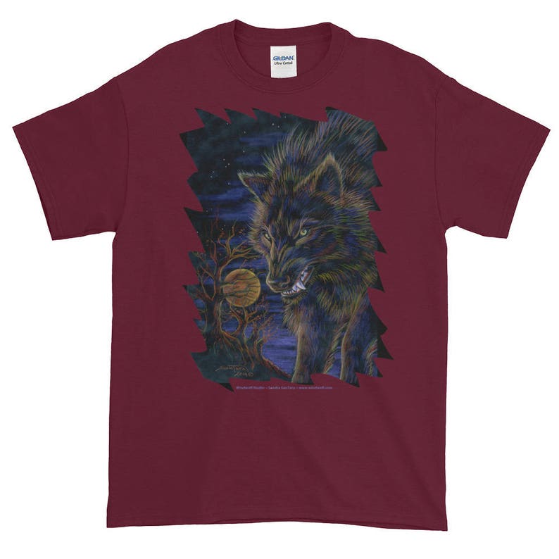 May include: A maroon t-shirt with a graphic print of a black wolf howling at the moon. The wolf is surrounded by a dark forest and a full moon.
