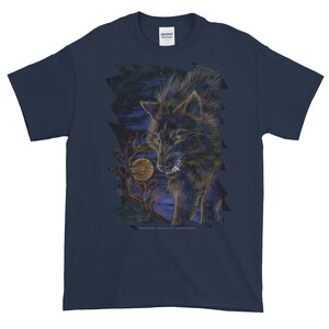 May include: A navy blue t-shirt with a graphic print of a black wolf howling at the moon. The wolf is surrounded by trees and a starry night sky.