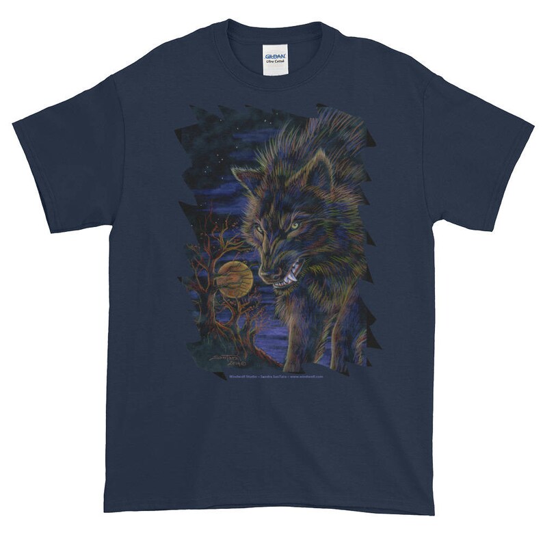 May include: A navy blue t-shirt with a graphic print of a black wolf howling at the moon. The wolf is surrounded by trees and a starry night sky.