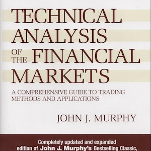 May include: A book titled "Technical Analysis of the Financial Markets" by John J. Murphy. The cover is white with brown text and horizontal stripes. It's a comprehensive guide to trading methods and applications.
