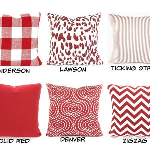 May include: Six red and white patterned throw pillows with different designs. The pillows are arranged in two rows of three. The pillow designs are: Anderson (red and white gingham), Lawson (red and white leopard print), Ticking Stripe (red and white ticking stripe), Solid Red (solid red), Denver (red and white circles), and Zigzag (red and white chevron).