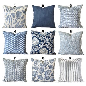 May include: A collection of nine square throw pillows featuring various blue and white patterns, including botanical prints, solid navy blue, geometric shapes, floral motifs, and vertical stripes, each numbered one through nine.