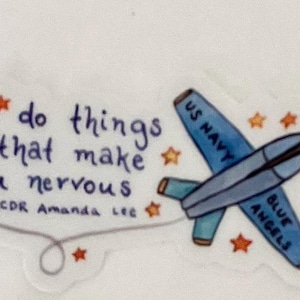 May include: A blue and white sticker with a drawing of a jet plane. The plane has "US Navy" and "Blue Angels" written on it. The sticker also has the quote "do things that make you nervous" and is attributed to "LCDR Amanda Lee".