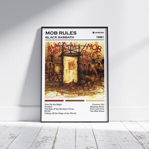 May include: Black Sabbath "Mob Rules" album art print. The poster features the album title and band name at the top, with the year 1981. The artwork depicts a dark, illustrative scene with figures and text. Song titles are listed at the bottom.