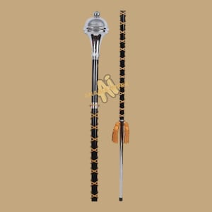 May include: A ceremonial mace and staff. The mace features a silver head and a black shaft with gold-colored cross-lacing. The staff is black with gold-colored cross-lacing and a gold tassel at the bottom. The mace is approximately 36 inches long.