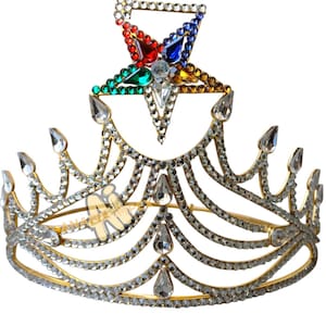 May include: A gold crown with a five-pointed star on top. The star is decorated with red, blue, green, and yellow jewels. The crown is adorned with clear rhinestones.