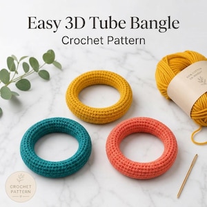 May include: Three crocheted tube bangles in teal, coral, and yellow, with a ball of yellow yarn and a crochet hook. The text "Easy 3D Tube Bangle Crochet Pattern" is at the top of the image.