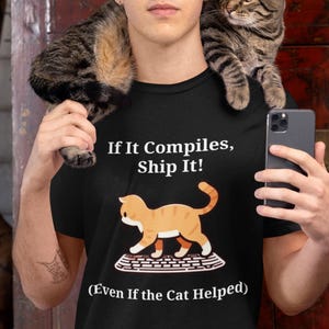 Funny Cat Coding T-Shirt: "If It Compiles, Ship It!"