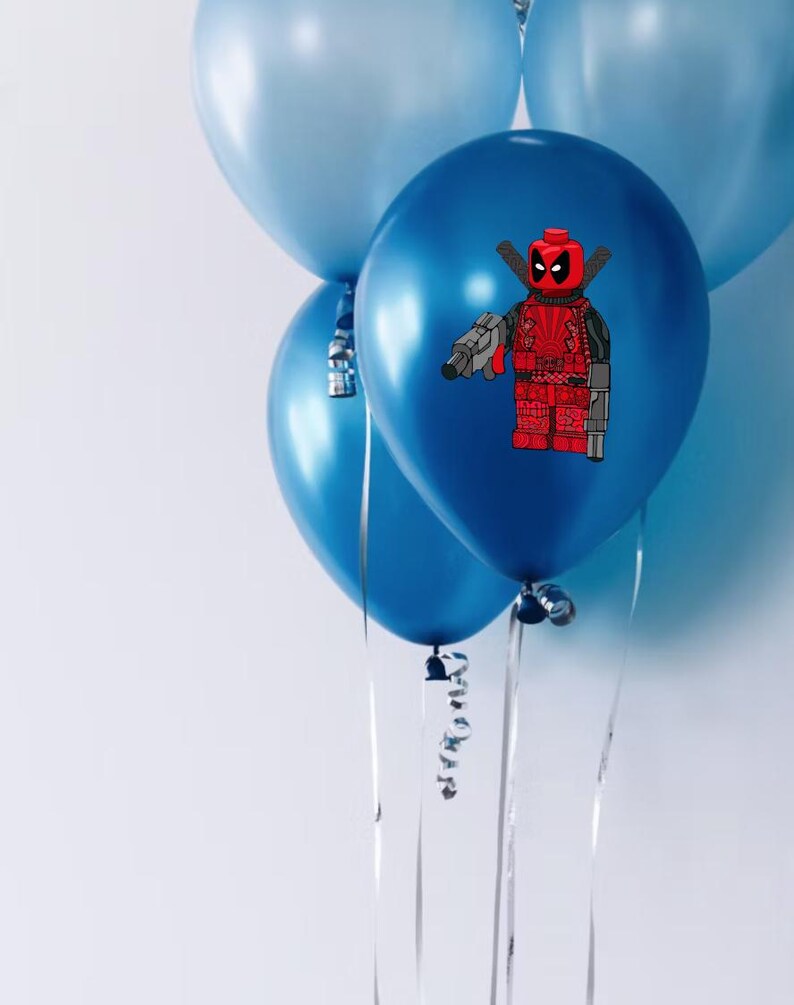 May include: Four blue balloons with silver ribbons. One balloon features a red and black Lego Deadpool character holding a gun.