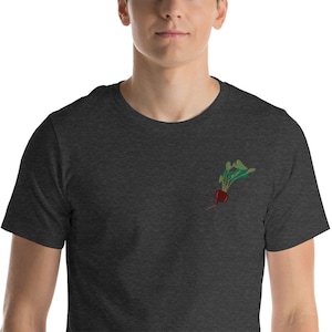 May include: A dark heather grey t-shirt with an embroidered image of a red beet with green leaves.