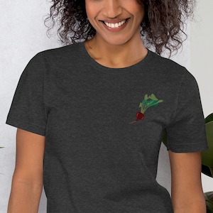 May include: A dark heather grey t-shirt with a small embroidered image of a red beet with green leaves.
