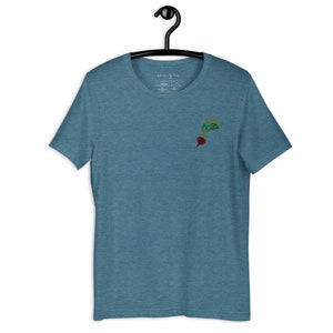 May include: A teal blue t-shirt with a small embroidered radish design on the left chest.