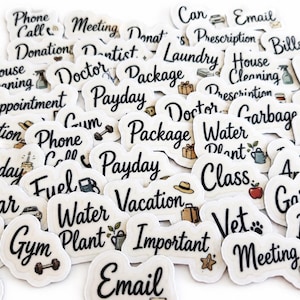 May include: A collection of white die-cut planner stickers featuring black cursive text and small colorful icons. The labels include words such as Phone Call, Meeting, Donation, Dentist, Laundry, Package, House Cleaning, Doctor, Payday, and Water Plant.