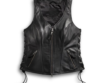 May include: Black leather vest with a V-neck, a zipper closure, and two zippered pockets. The sides feature lace-up detailing. The vest is sleeveless and has a smooth, shiny finish.