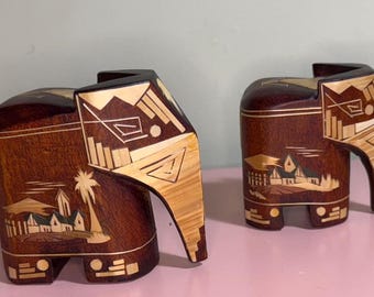 Two wooden elephants, mother and calf, hand-carved, detailed inlay work contrasting light-colored wood or bone, enhancing the dark wood base