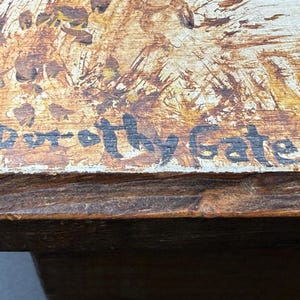 May include: Close-up of a wooden box with a painted top. The artwork features a blend of brown, tan, and white hues. The artist's signature, "Dorothy Gates," is visible in black script. The box has a dark brown wooden frame.