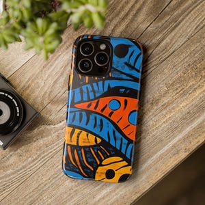 May include: A phone case with a colorful abstract design featuring blue, orange, and yellow shapes on a black background. The case has a cutout for the phone's camera.