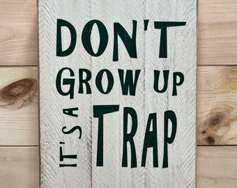 Don’t grow up it’s a trap distressed sign