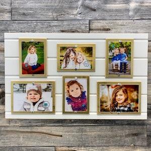 May include: A white wall with six gold picture frames, each containing a photo of a child. The photos are arranged in two rows of three. The frames are all the same size and shape, and they have a simple, modern design.