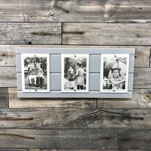 May include: A gray wooden picture frame with three black and white photos. The photos show children in various settings.