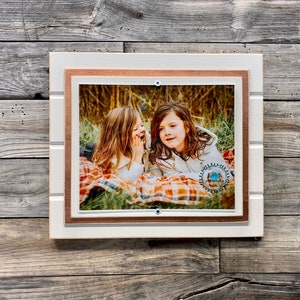 White and copper colored picture frame holds 8"x10"