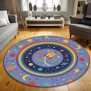 May include: A round, space-themed rug with a light purple background. The rug features a rainbow, planets, stars, a rocket ship, and cartoon aliens. The rug is designed for a child's room or playroom.