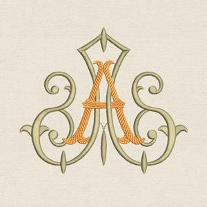 May include: Embroidered monogram letter "A" in gold and olive green, featuring ornate scrollwork and a decorative top. The design is set against a neutral background. Text reads "Tyumiko 4 sizes" and "Natasha Tyumiko".