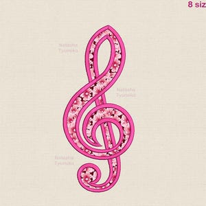 May include: A pink treble clef design with a floral pattern filling the interior. The design is outlined in a darker pink and features the text "Natasha Tyumiko" and "Tyumiko 8 sizes".